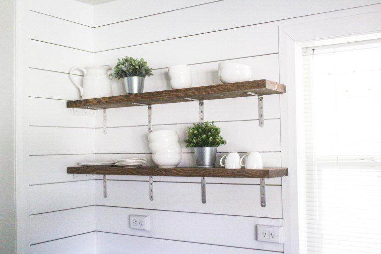 Stained shelf with brackets on shiplap