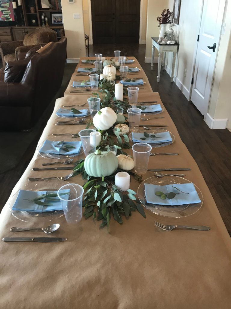 Long table that is set with halloween decorations
