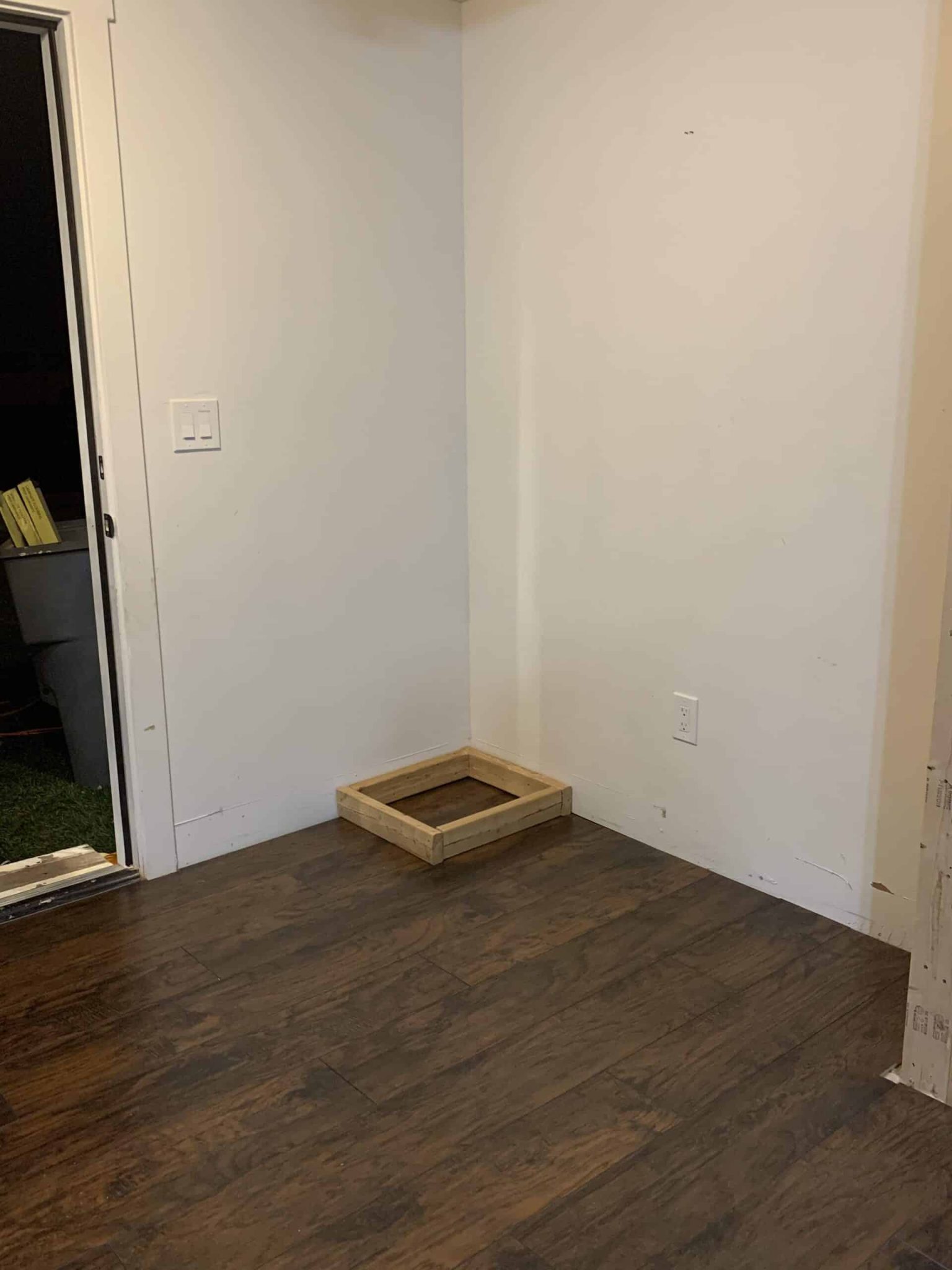 Wooden square on the ground in an entryway