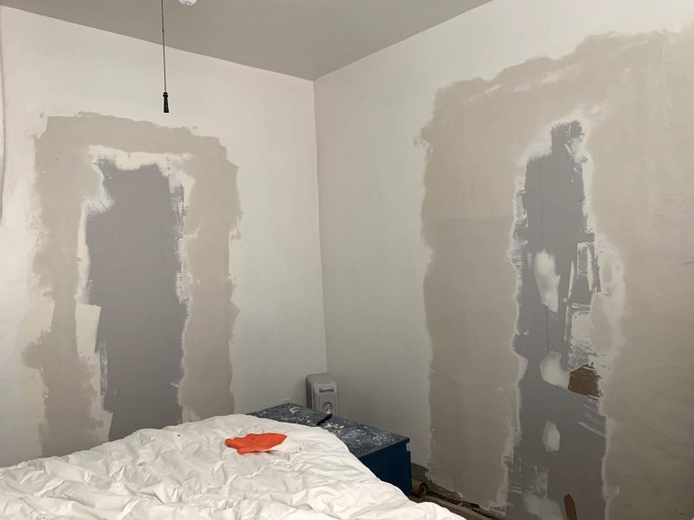 Two areas in a bedroom with joint compound on the wall