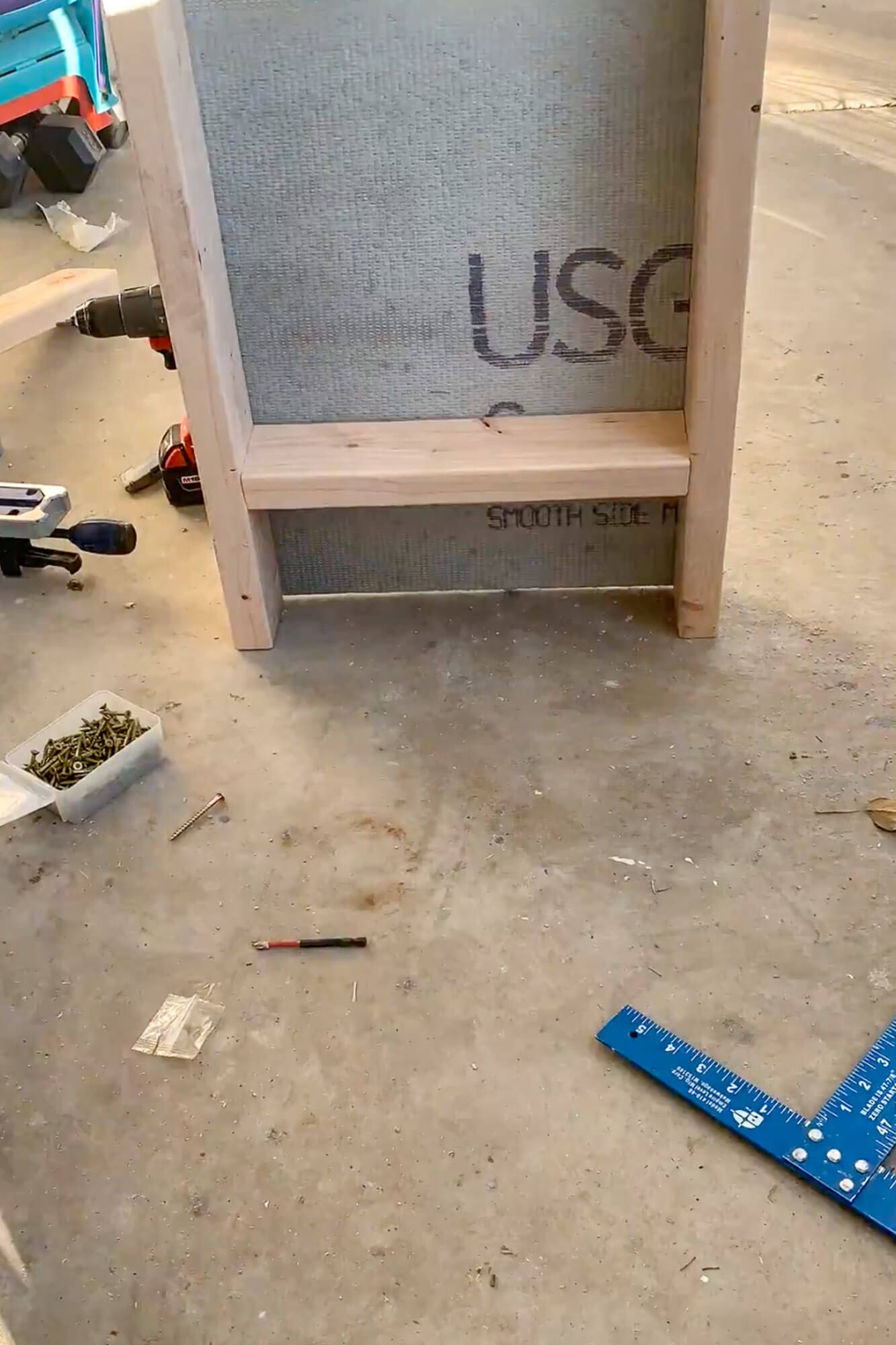 DIY shower niche frame with cement board on workbench during shower mold removal—how to remove shower mold and prep walls for tile.