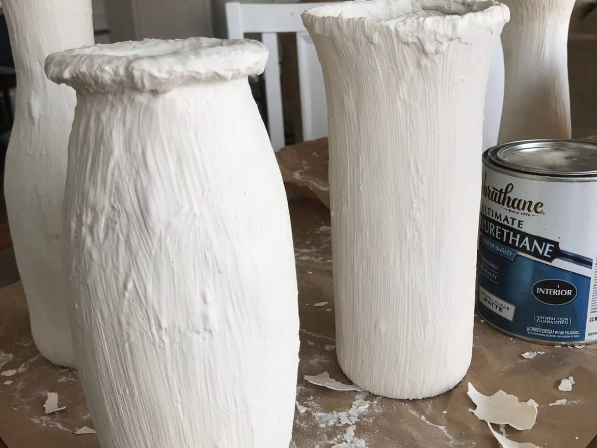 Three glass vases painted white