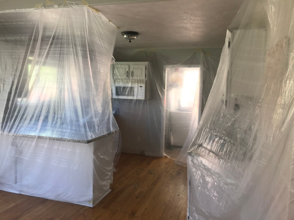 Kitchen taped with plastic sheeting