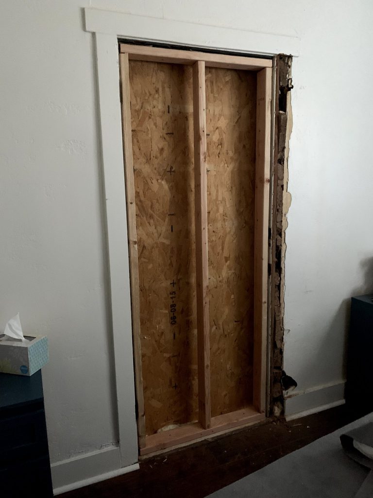 Wooden boards and plywood door
