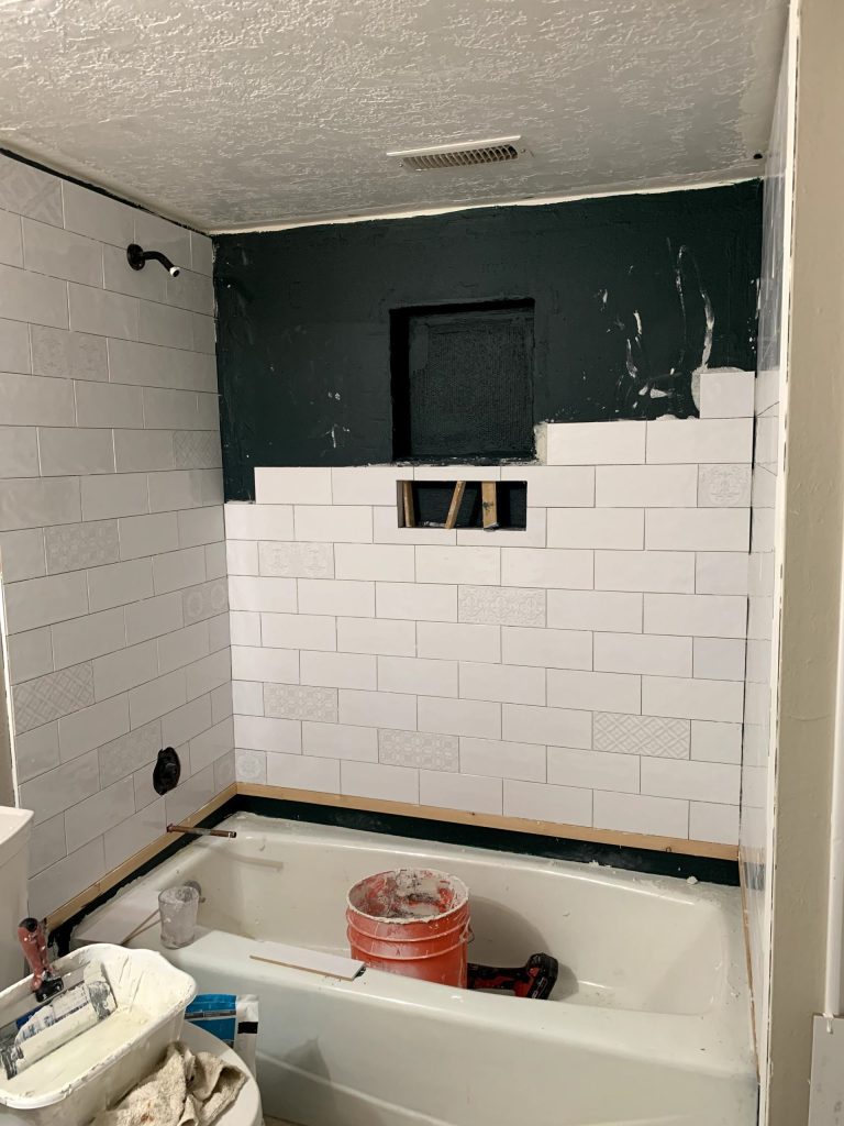 White shower tile half installed