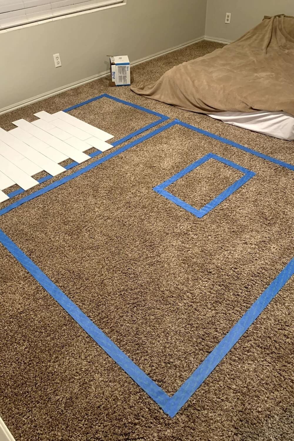 Planning shower tile layout on floor with white subway tiles.