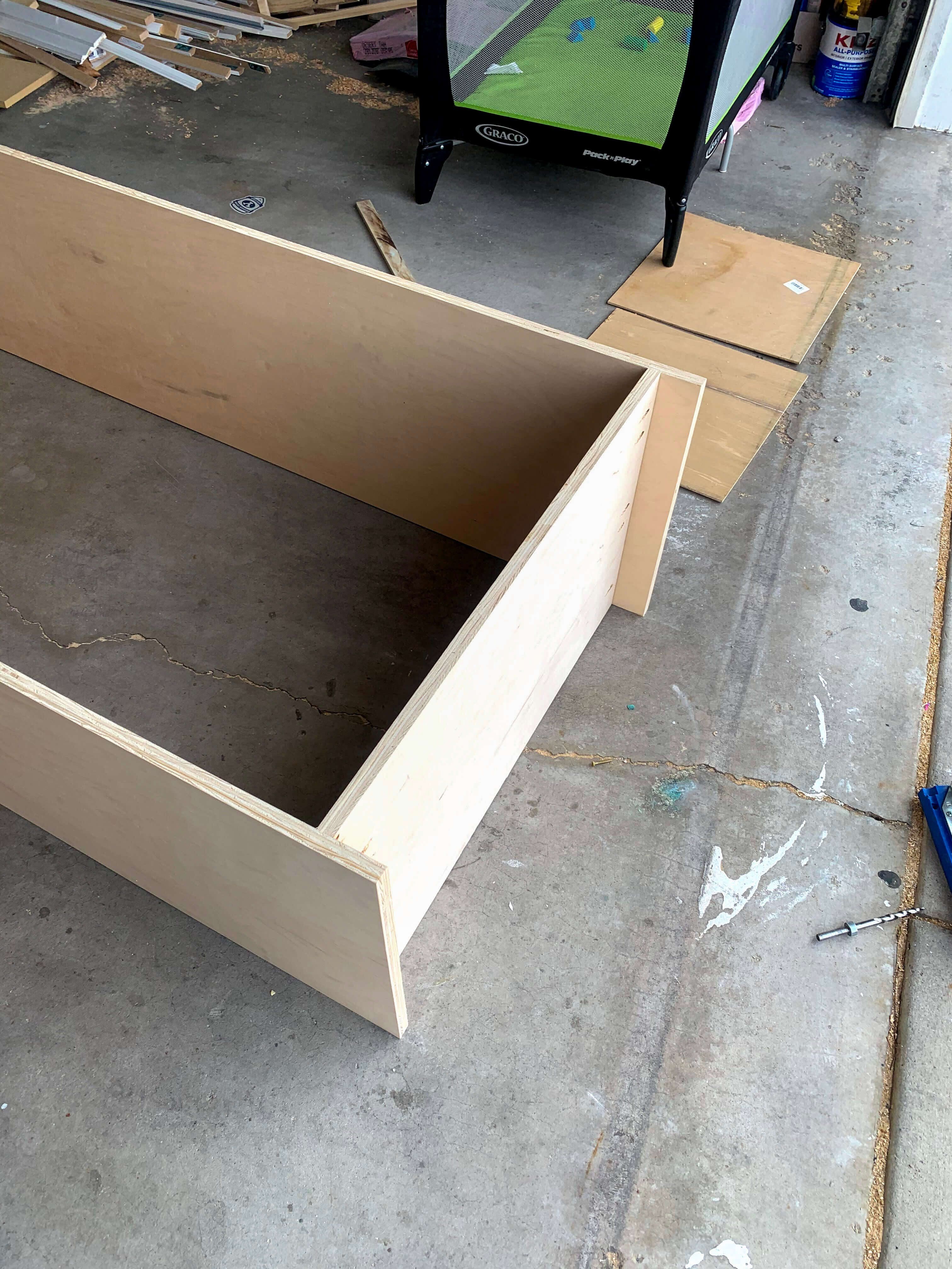 DIY built-in office cabinet frame laid out on the floor before assembly, ensuring precise cuts and measurements.