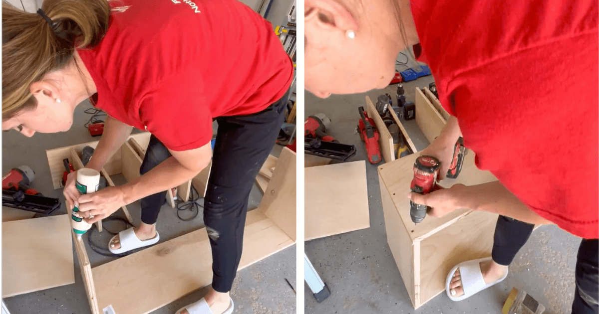 Woman in red shirt using a drill on wood