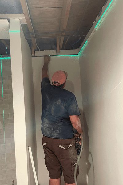 man installing drywall