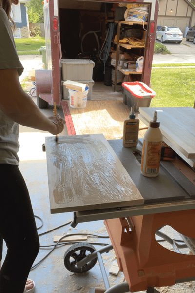 Woman putting glue on wood