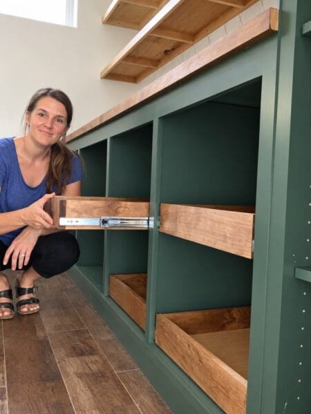 Crystel kneeling beside a pine drawer pulled out on full extension drawer slides