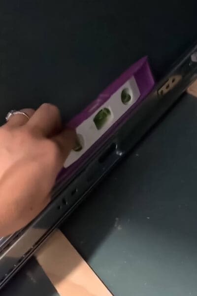 small level on a drawer slide inside a green cabinet
