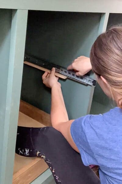 Crystel lining up an upper drawer slide on its spacer