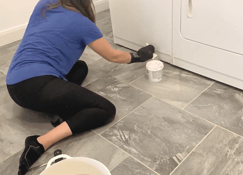 Finger pointing to grey tile