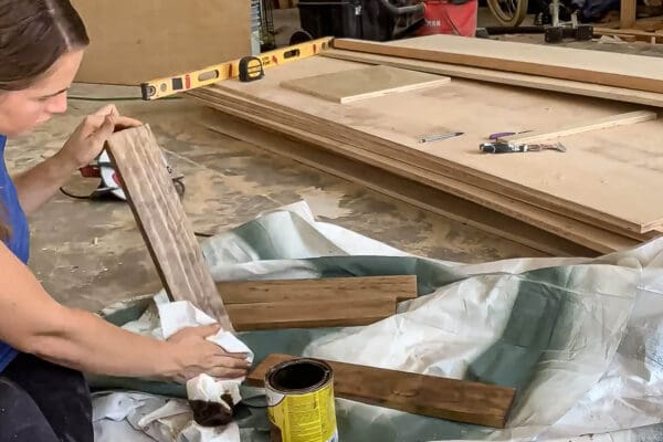 Crystel staining pine boards for the drawer sides on a drop cloth