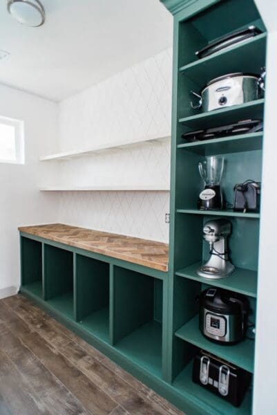 finished DIY butler's pantry appliance cabinet in green with a herringbone counter and floating shelves