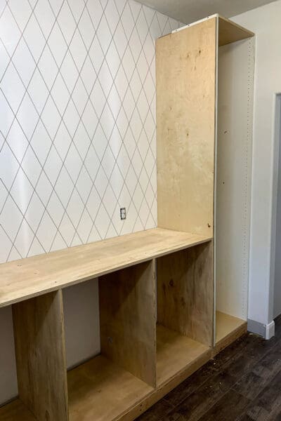 unpainted plywood pantry cabinets with a plain plywood top before the herringbone countertop