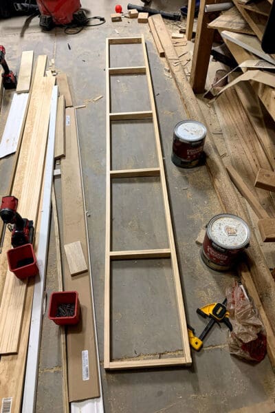 1x2 pine shelf frame with supports on a garage floor