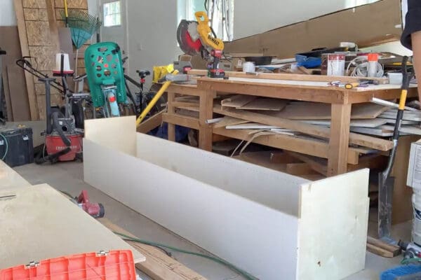 tall melamine cabinet box assembled on its side in the garage