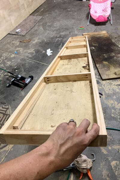 underside of a floating shelf showing the 1x2 supports and plywood top