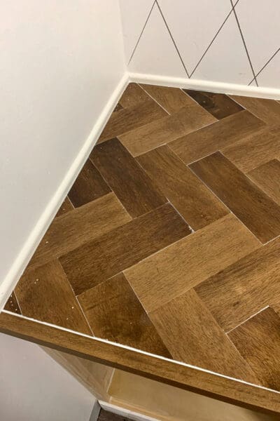 clear caulk in the herringbone countertop seams along the front edge trim