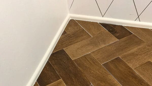 shoe molding along the wall where the herringbone countertop meets the corner