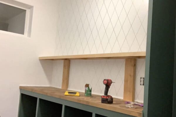 lower floating pantry shelf installed with scrap wood spacers standing on it