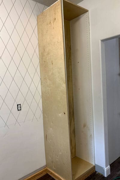 plywood side panel covering the melamine side of the tall butler's pantry cabinet