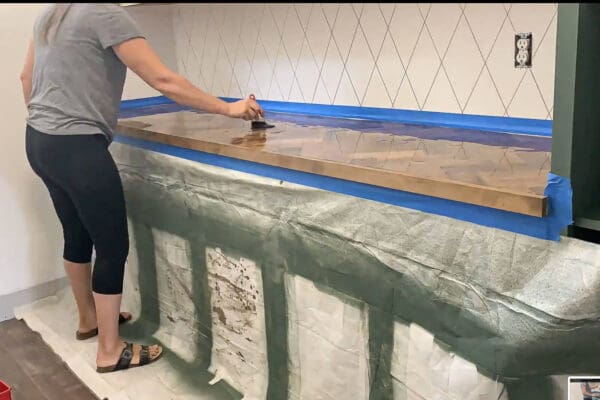 spreading epoxy across the herringbone wood countertop