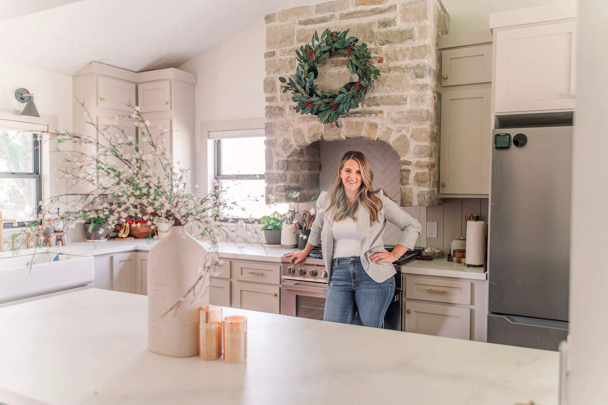 woman standing in front of Shaker-style cabinet doors installed in an affordable kitchen remodel