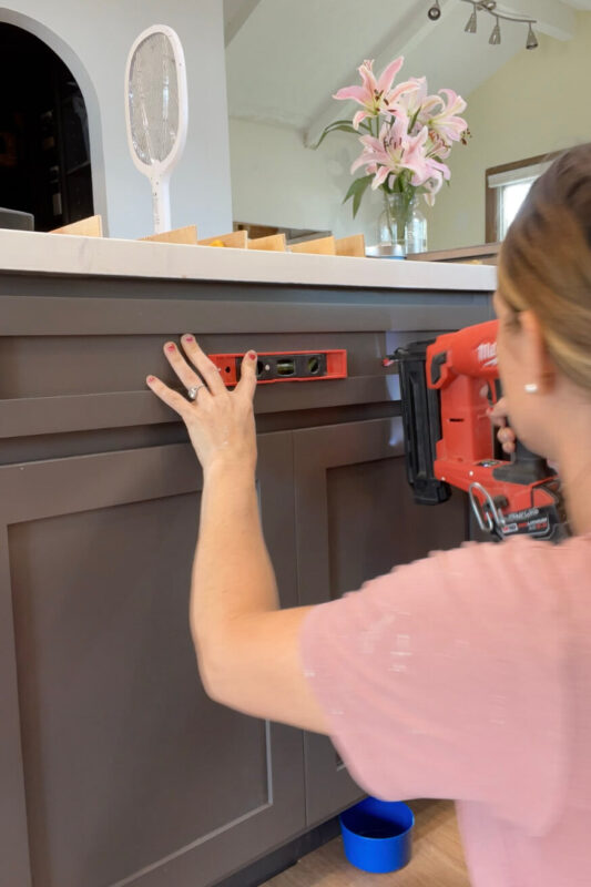 Installing drawer fronts with a nail gun in an affordable kitchen remodel