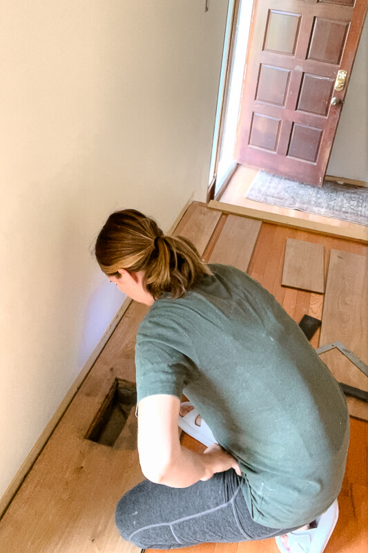 cutting out an air vent in wood flooring