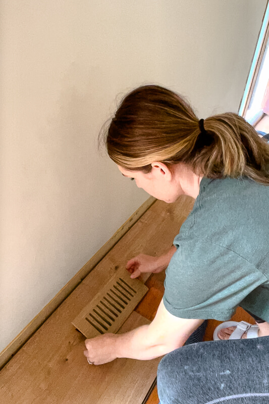 cutting out an air vent in wood flooring