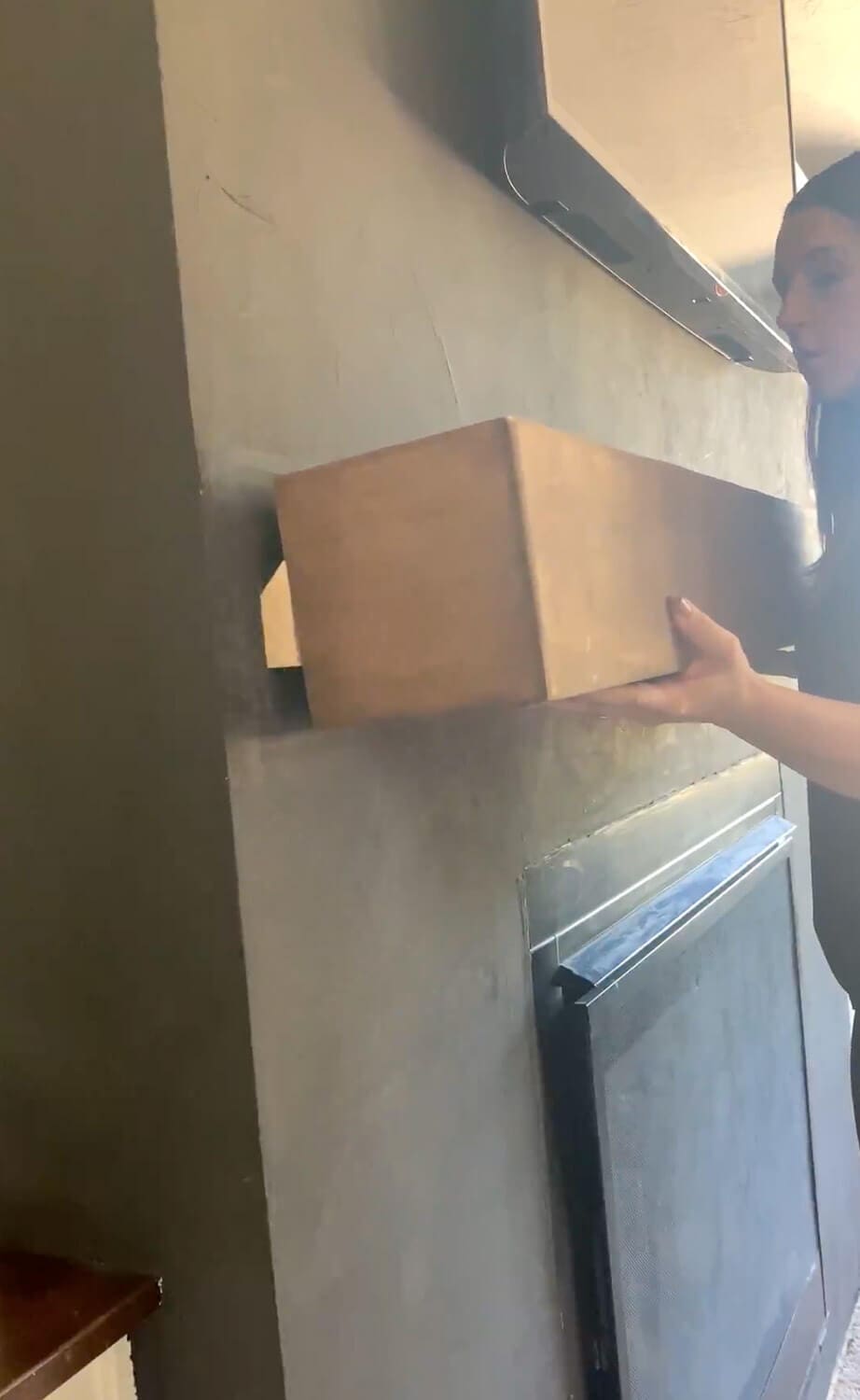 French cleat piece being held showing how 45-degree angle hooks onto wall cleat