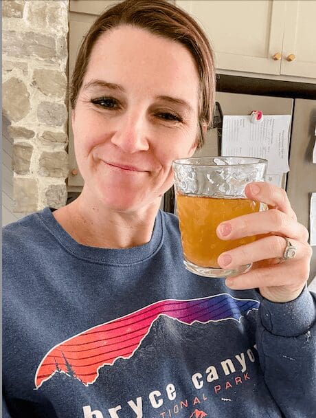 Woman holding cup of bone broth