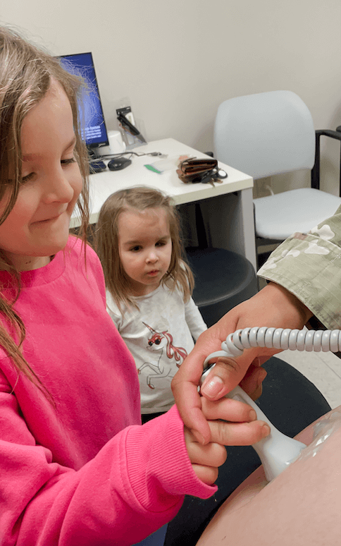 little girl helping with ultrasound