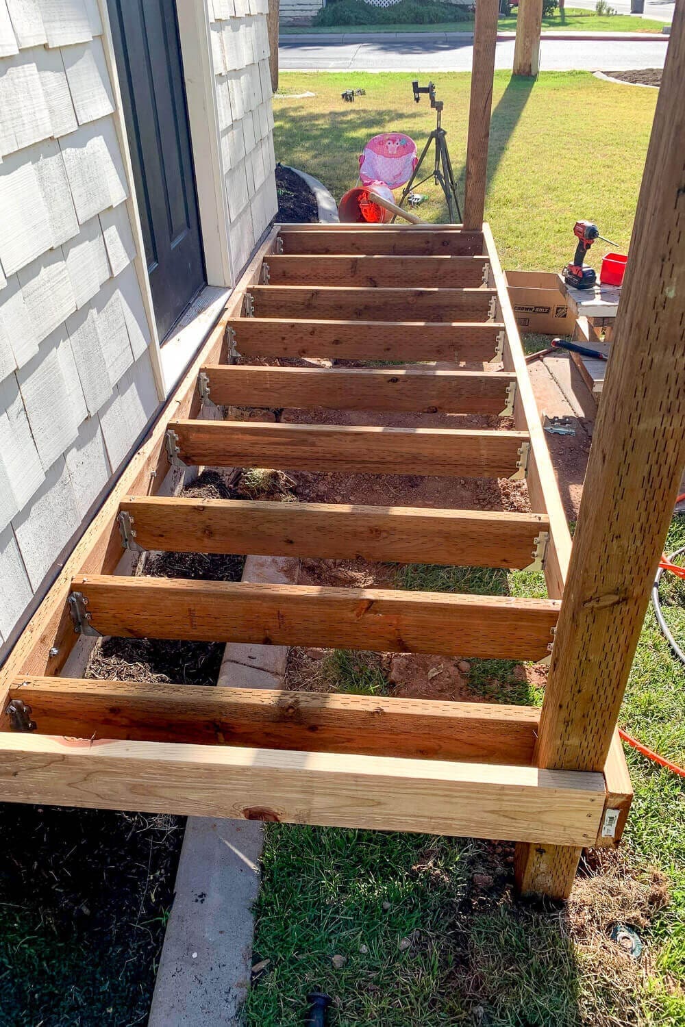 Overhead view of the finished porch joist frame, evenly spaced and ready for deck boards.
