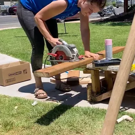 woman cutting wood for a white front porch