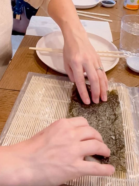 folding sea weed for a sushi roll