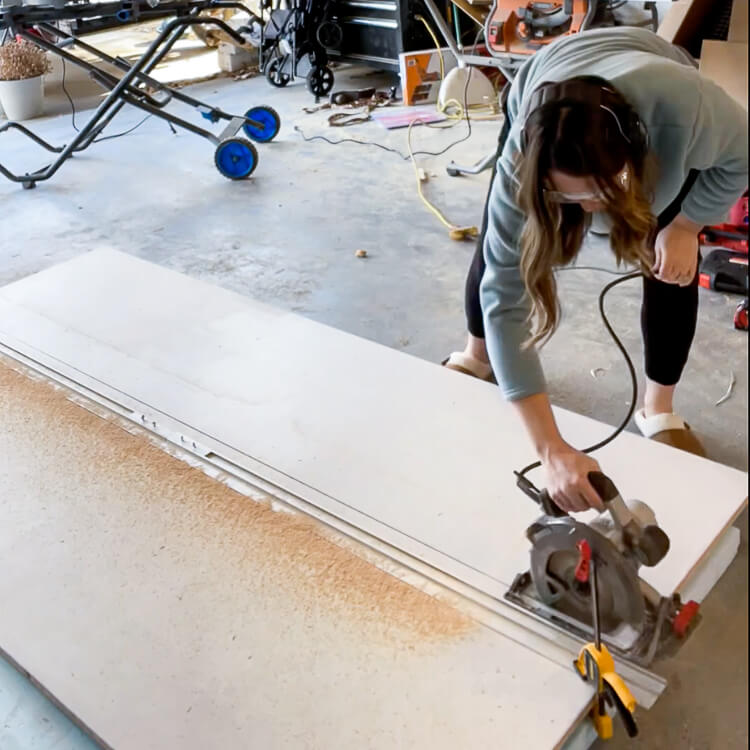 woman cutting plywood with a circular saw