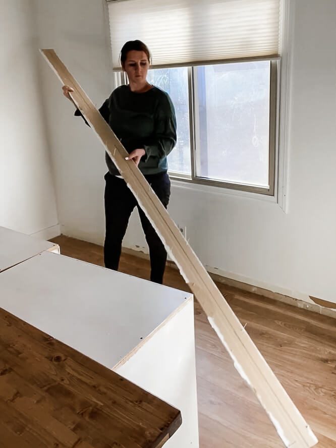 woman removing baseboards