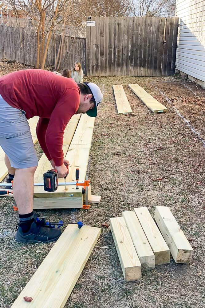 man clamping wood for a planter box