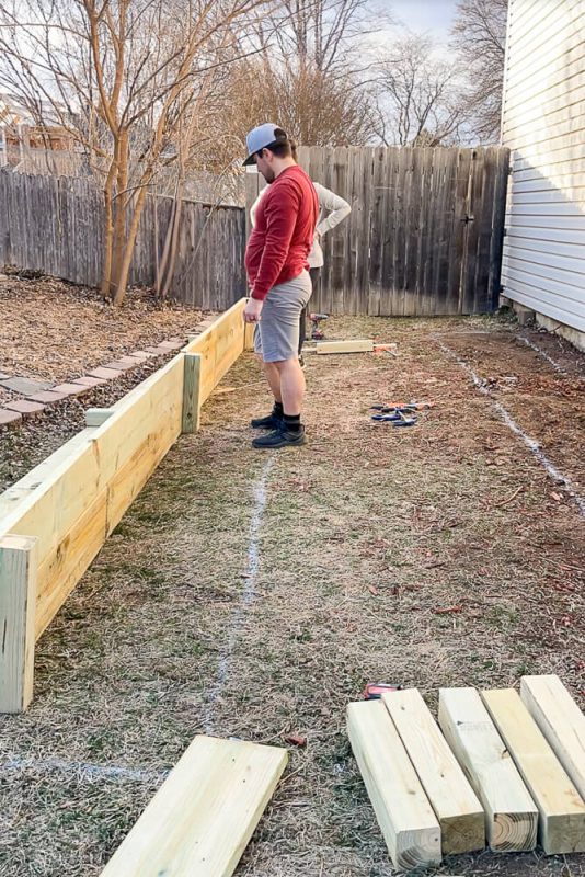man building a raised garden bed