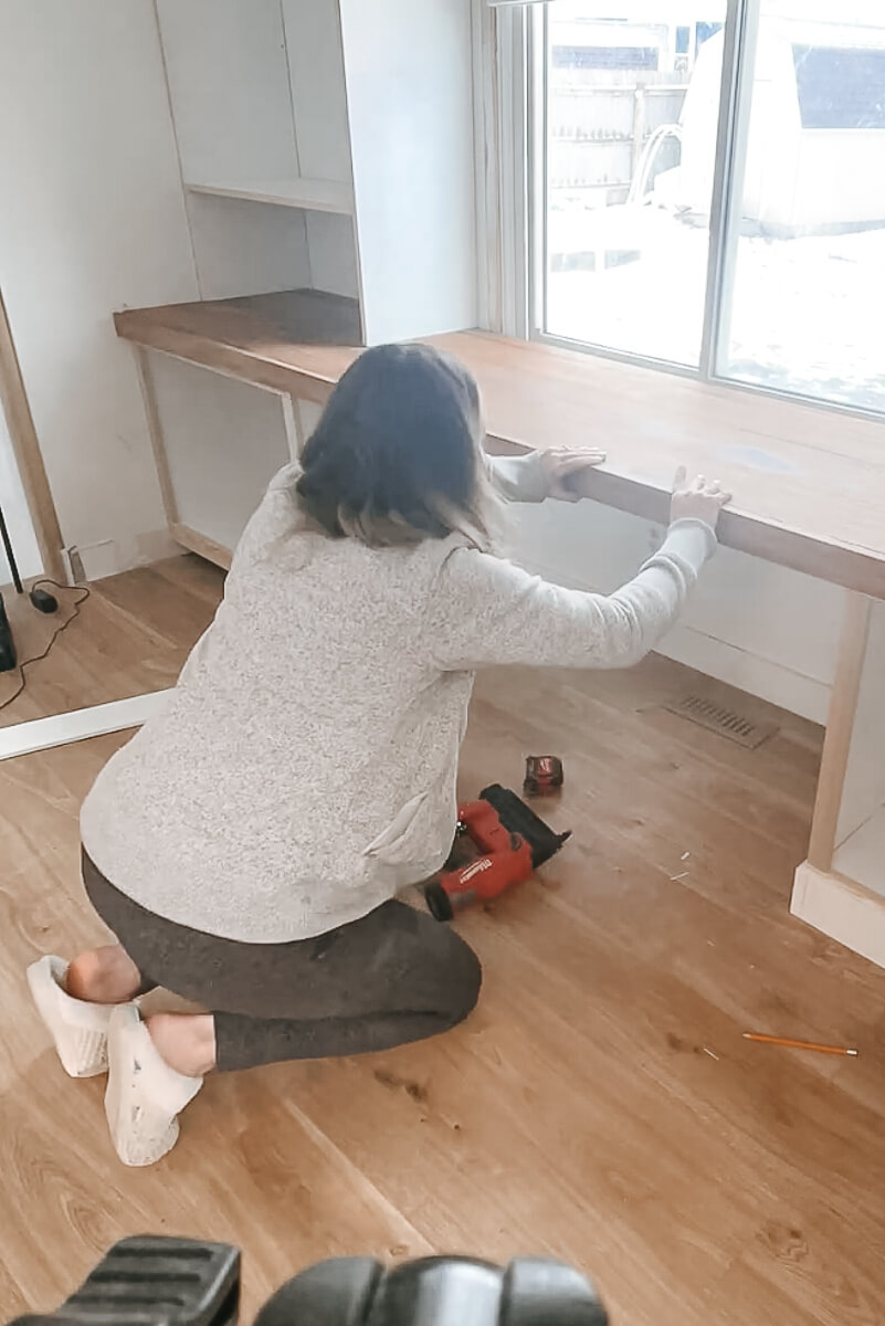 Woman installing a frame onto a desktop