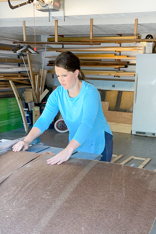 woman cutting hardboard