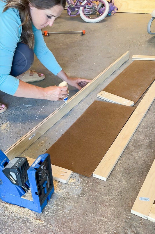 woman using wood glue on shaker doors