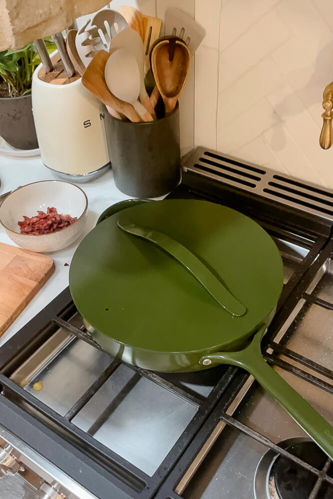 Green skillet covered with a matching lid on the stovetop