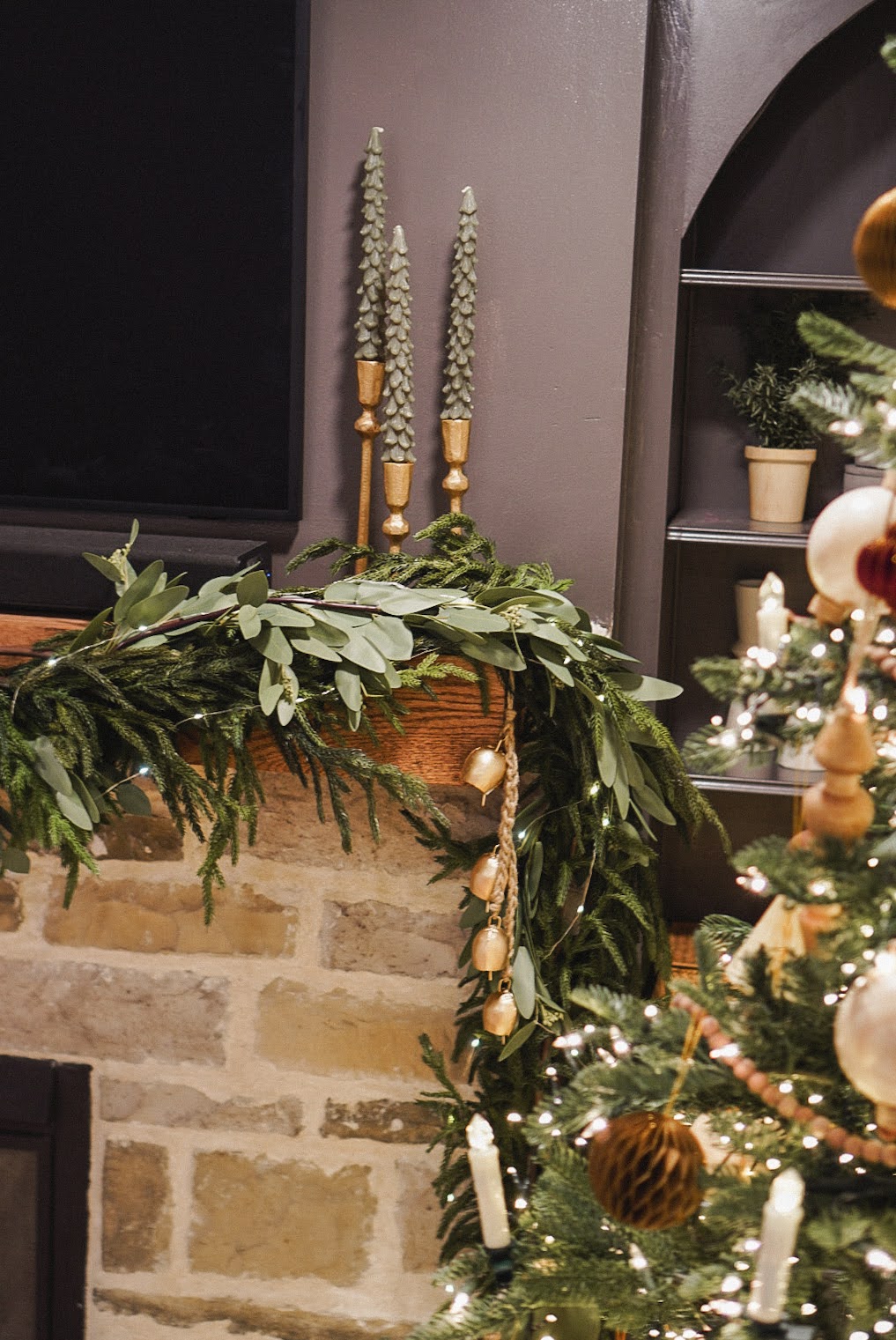 garland and Christmas candles on mantel with traditional Christmas decor