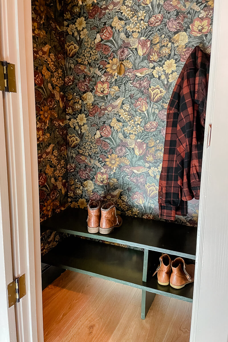 Beautiful coat closet makeover with green shelves and wallpaper