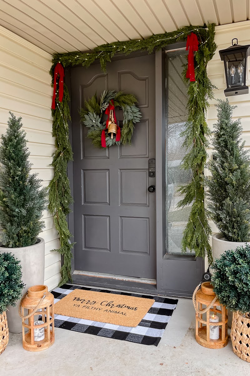 Front porch and front door after adding wreath and garland set and Christmas decorations